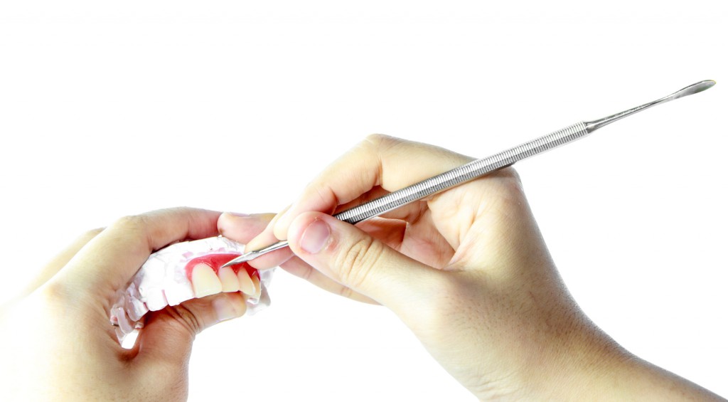 Woman hand Make denture with tool